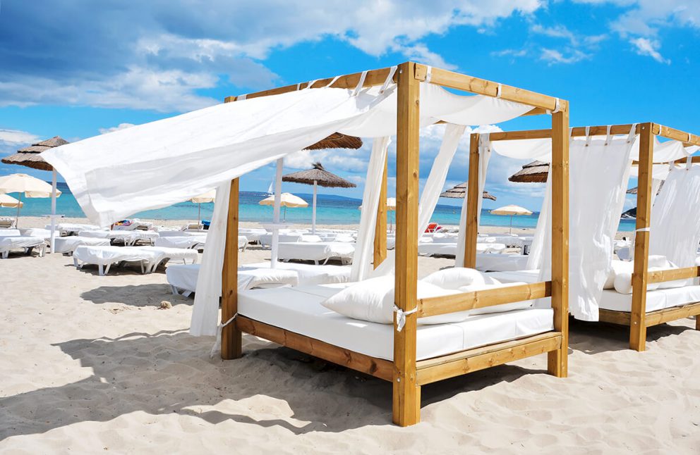 white four poster bed on beach