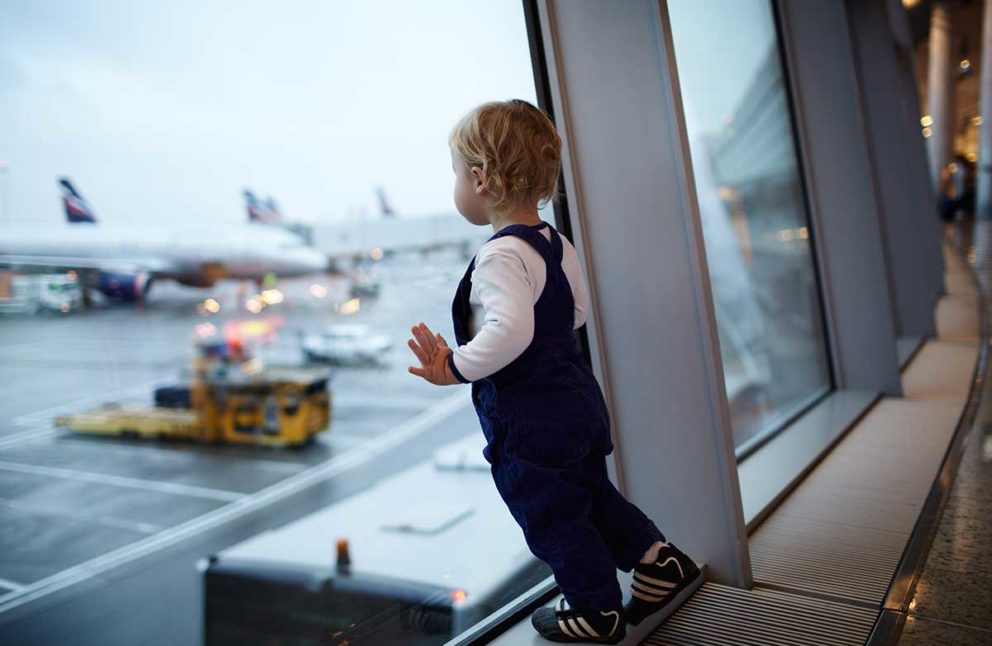 Child waiting airport watching planes