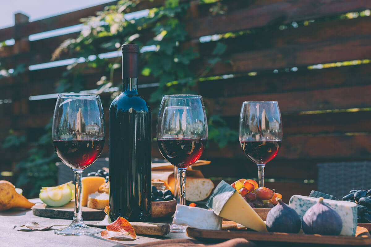 wine and cheese on table outdoors