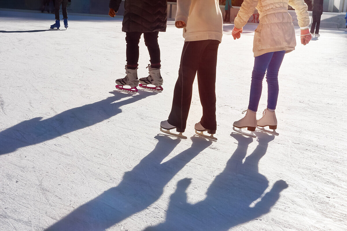 friends ice skating at Christmas