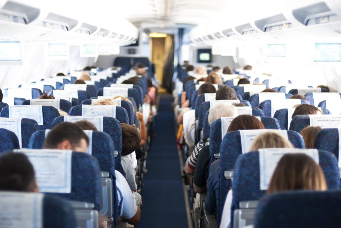 blurry defocused image of passenger on airplane passengers on plane aisle