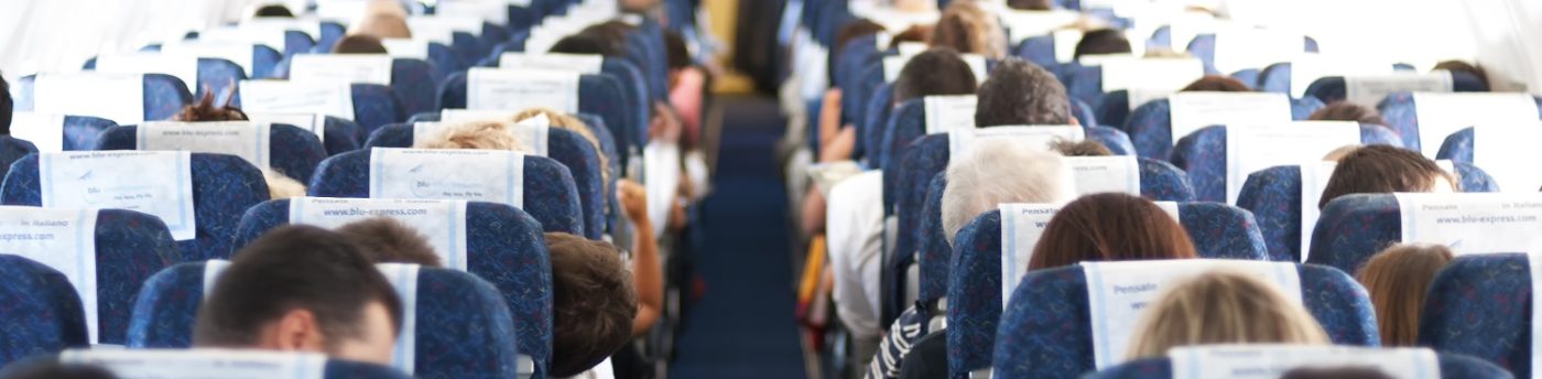 blurry defocused image of passenger on airplane passengers on plane aisle