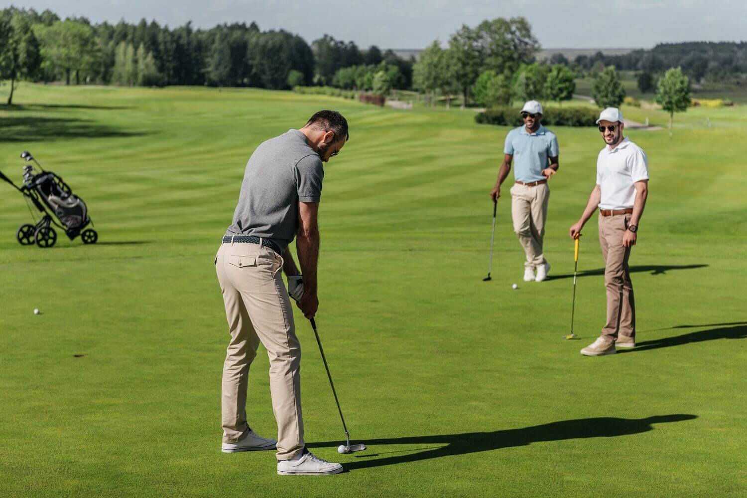 golfer putting with friends