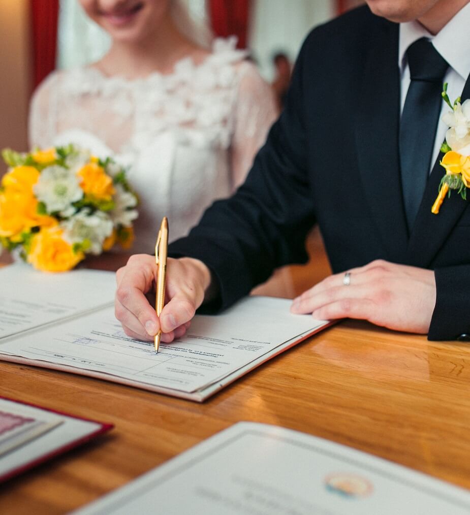 Married couple signing paperwork