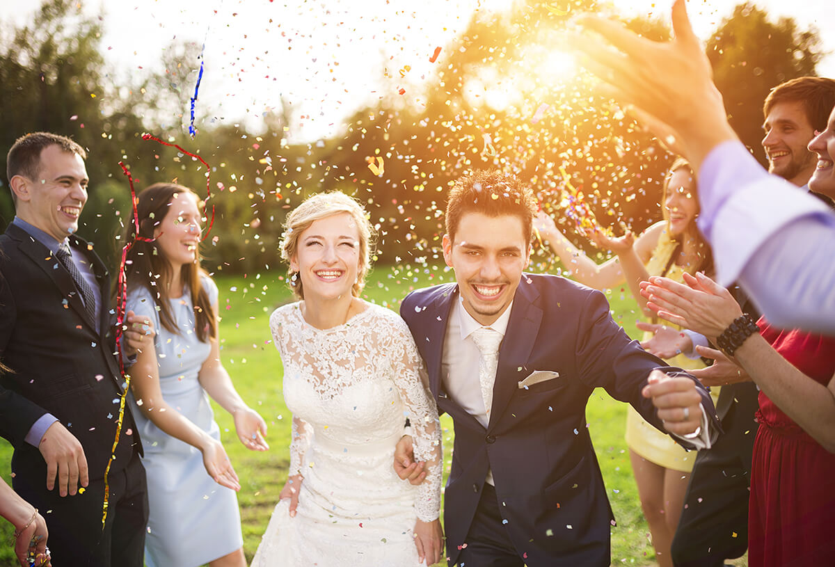 recently married couple being covered in confetti