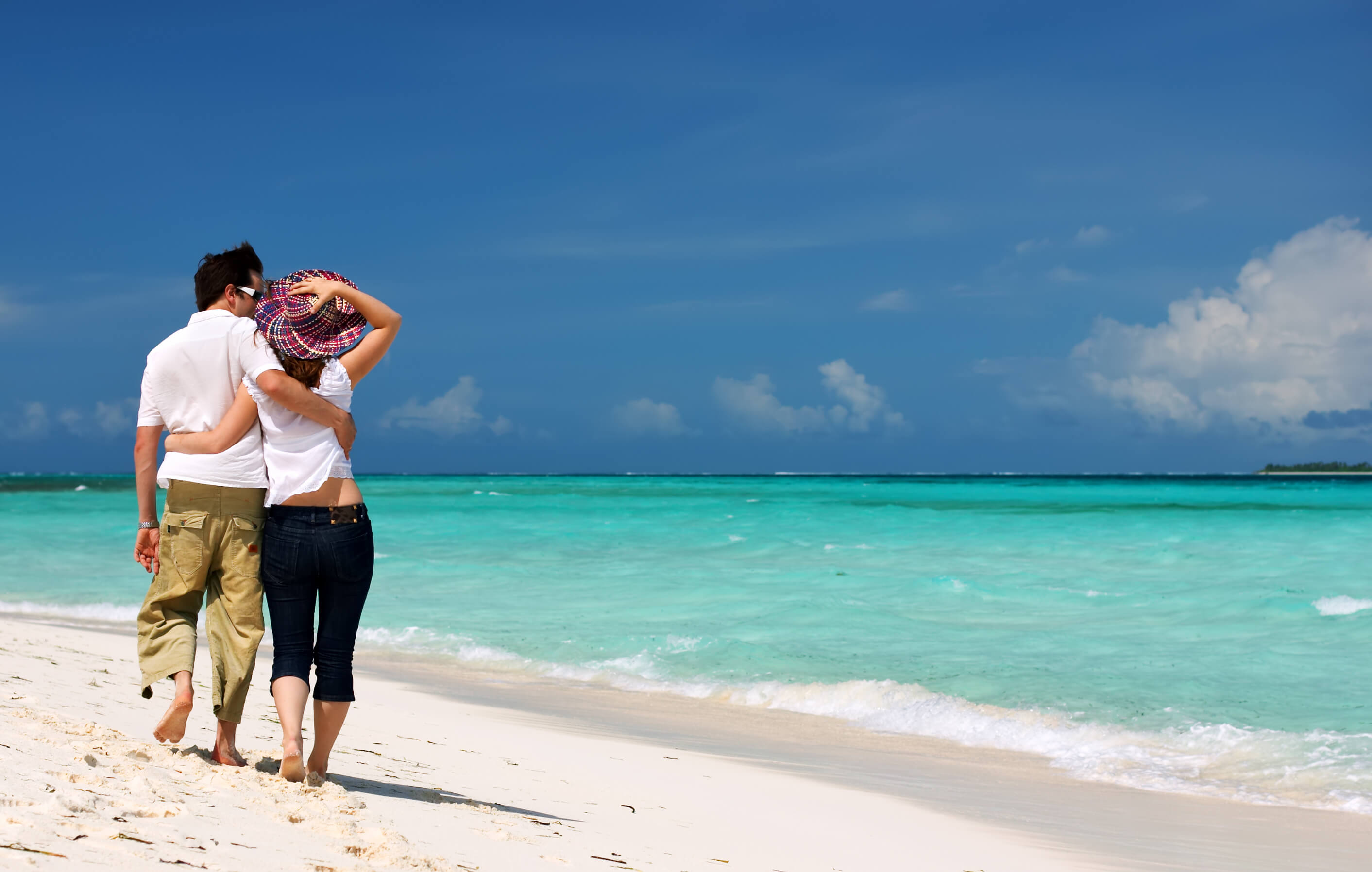 couple on beach looking out at the ocean