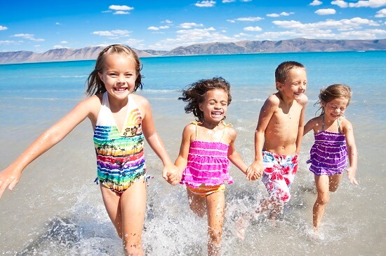 children running in shallow water